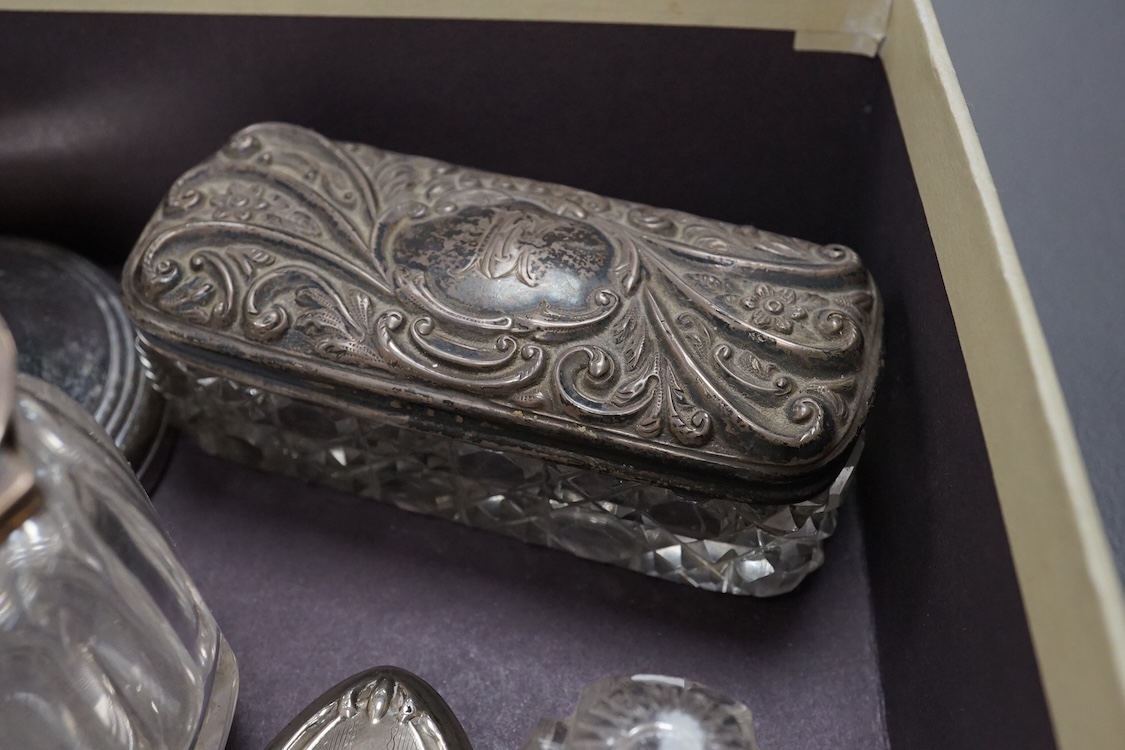 Two silver mounted hand mirrors including Reynold's Angels, Chester, 1899, 26.7cm, together with four silver mounted dressing table implements, a pair of silver mounted dwarf candlesticks and four assorted silver mounted